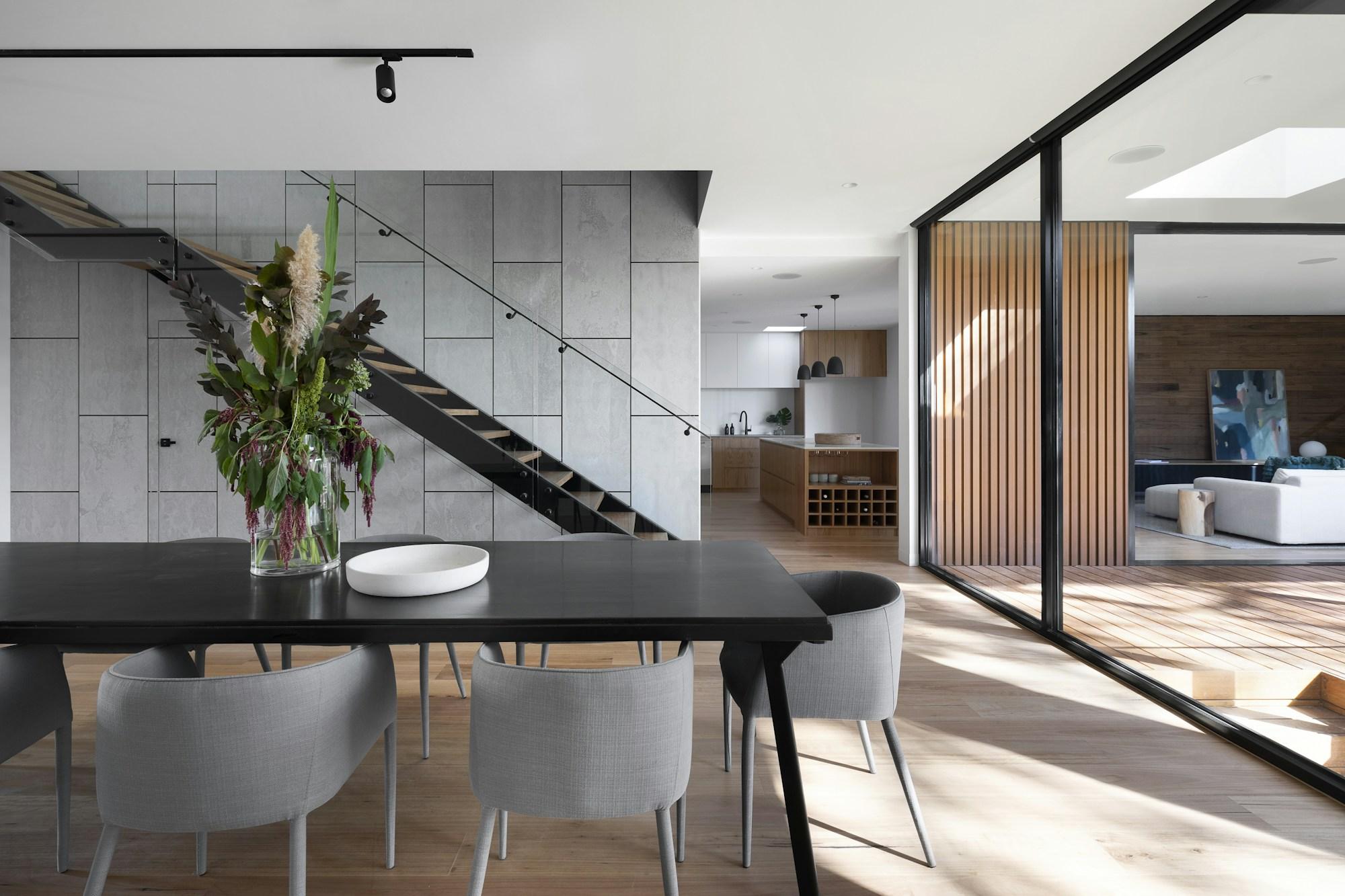 Natural materials and integrated timber cabinetry in an architectural reference interior